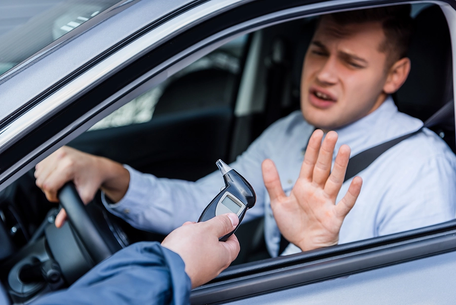 A police officer administrating a breathalyzer test