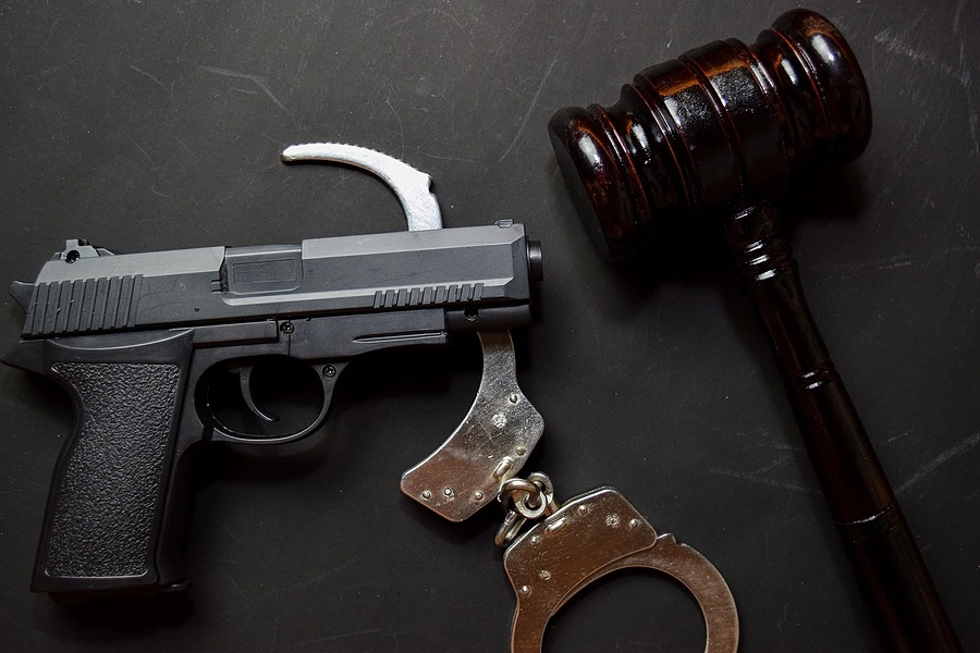 A gavel, gun, and handcuffs symbolizing Fort Pierce Weapon Lawyer's commitment to justice.